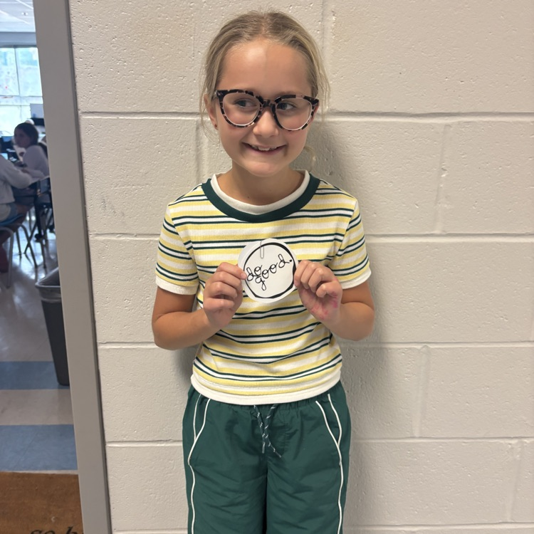 student holding up a do good award 