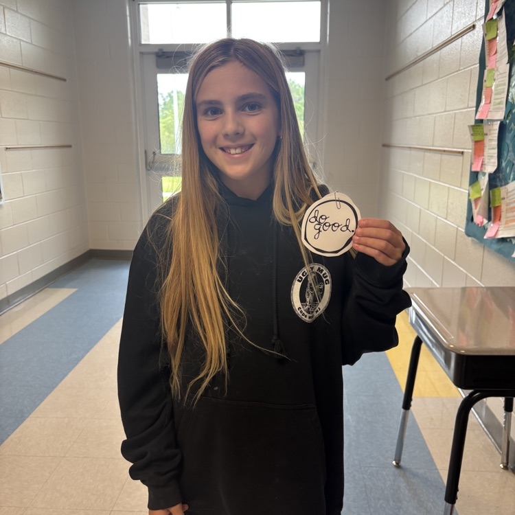 student holding up a do good award 