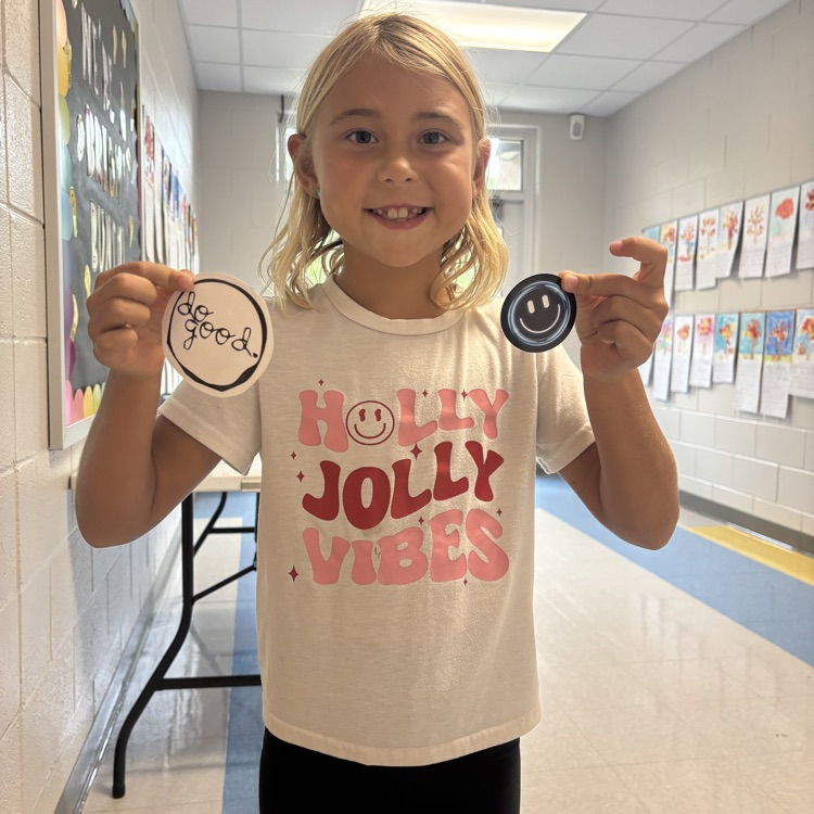 student holding up a do good award 