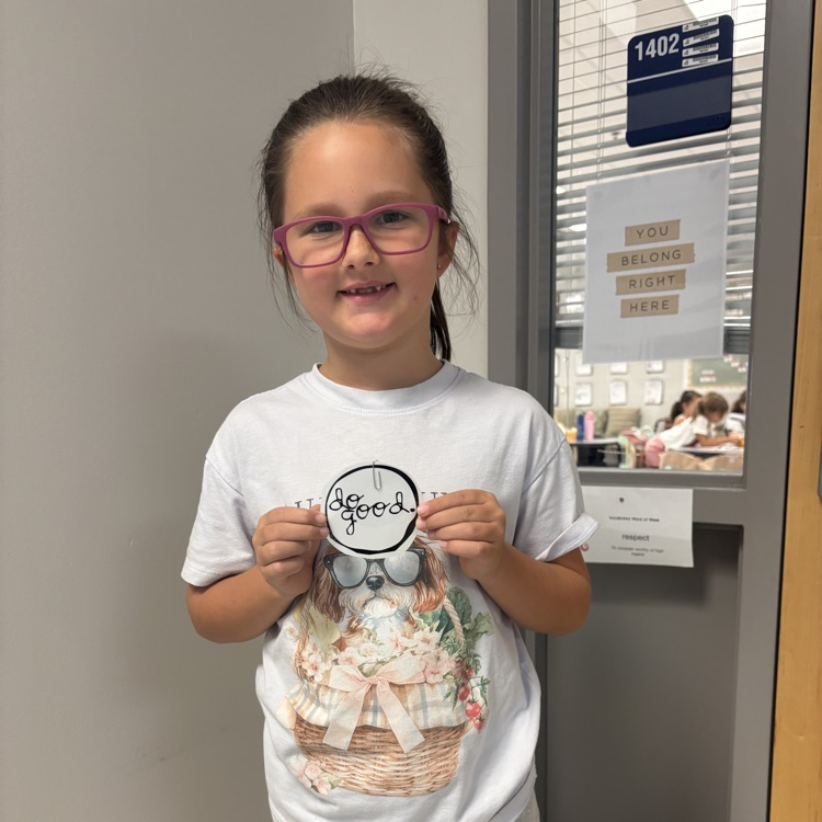 student holding up a do good award 