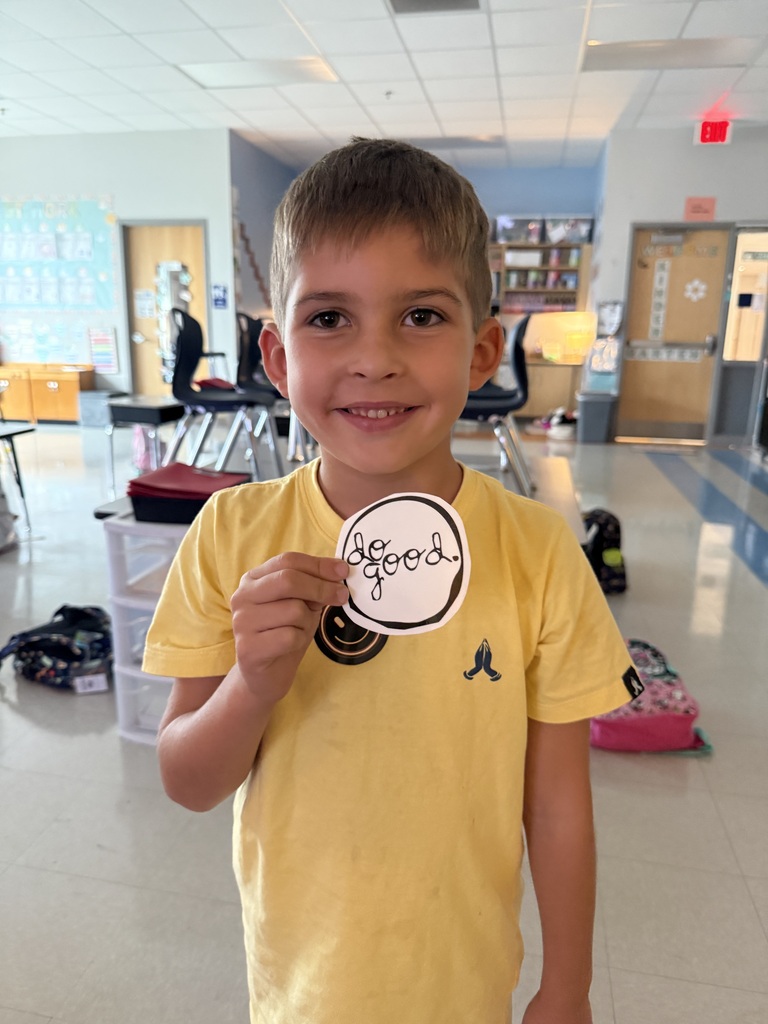 student holding up a do good award 