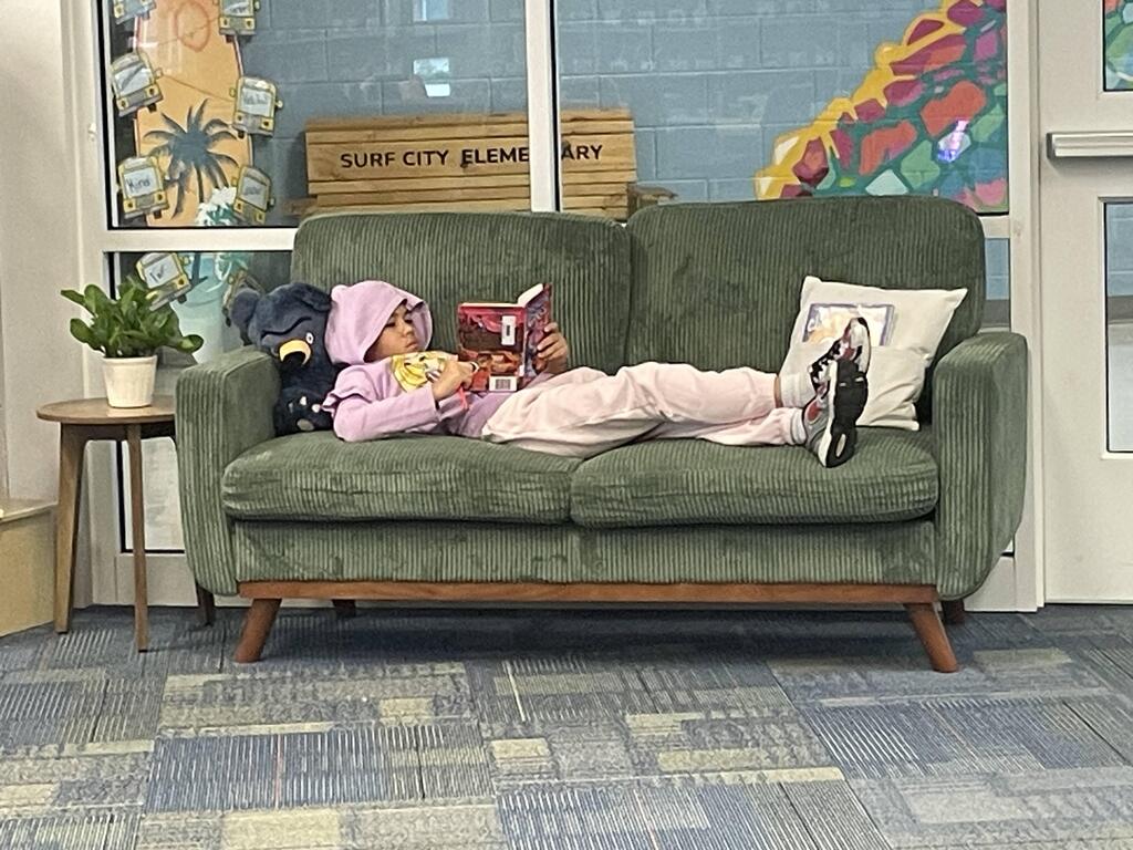 students reading on couches in the library