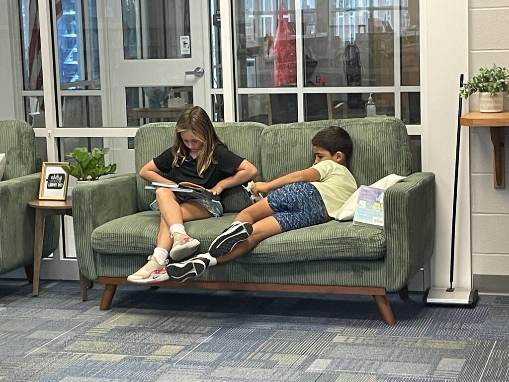 students reading on couches in the library