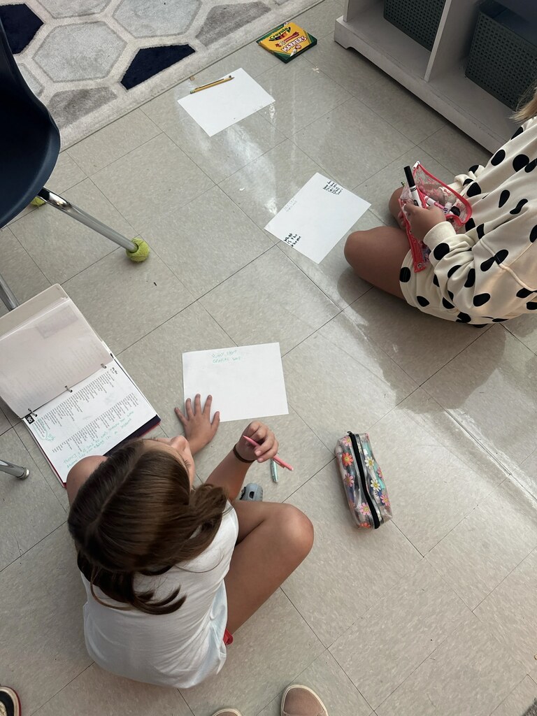 4th graders working on a project at their tables