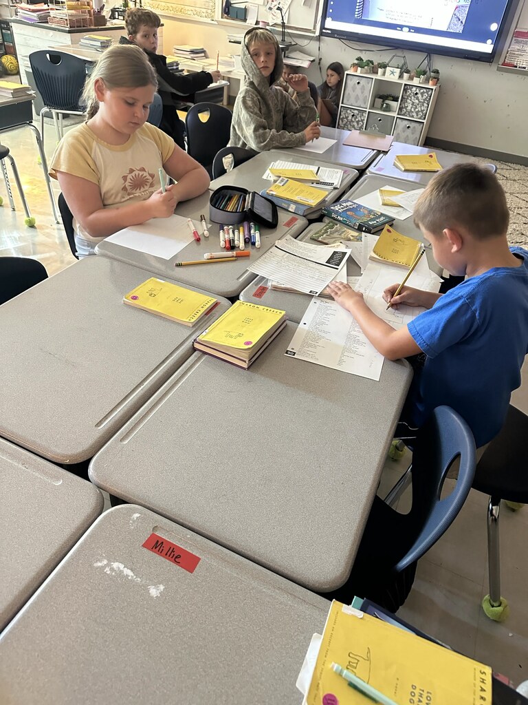 4th graders working on a project at their tables