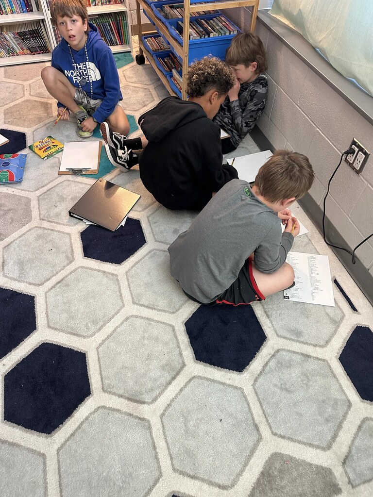 4th graders working on a project at their tables