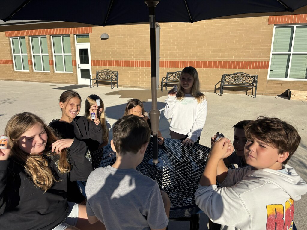 5th graders doing a science experiment outside
