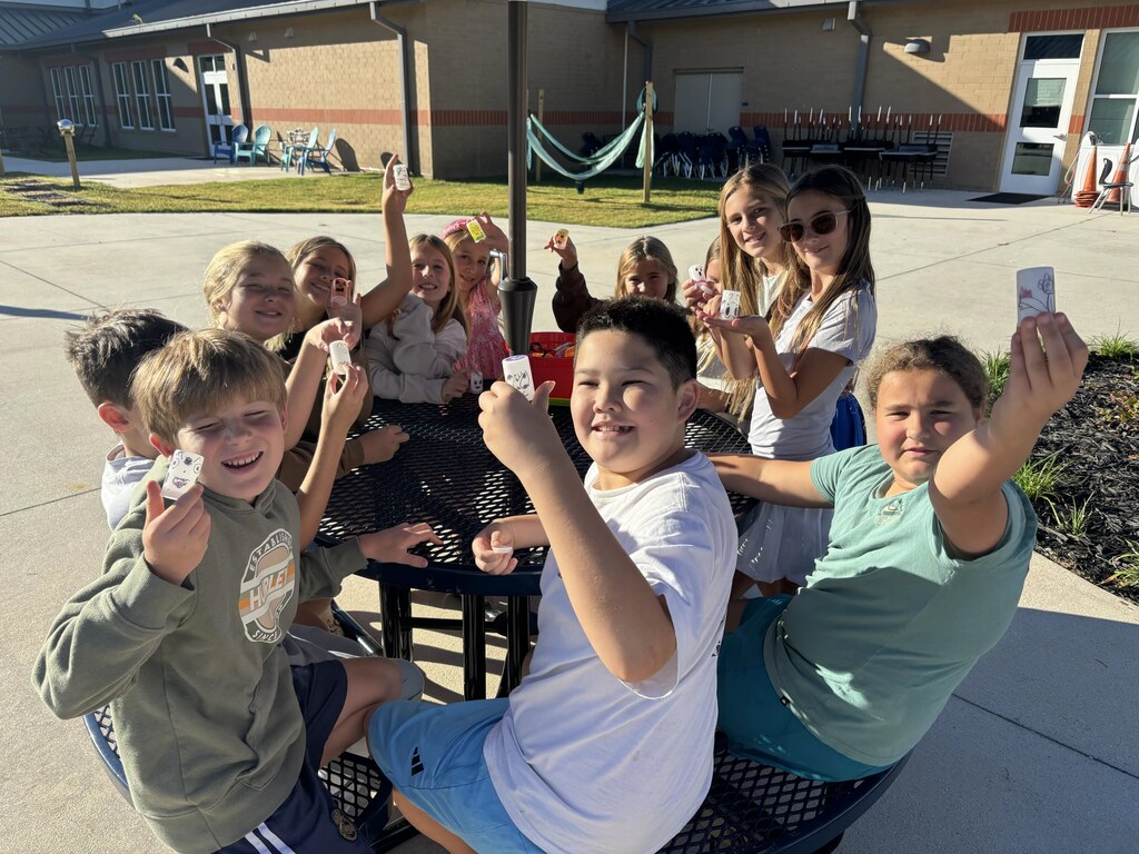5th graders doing a science experiment outside