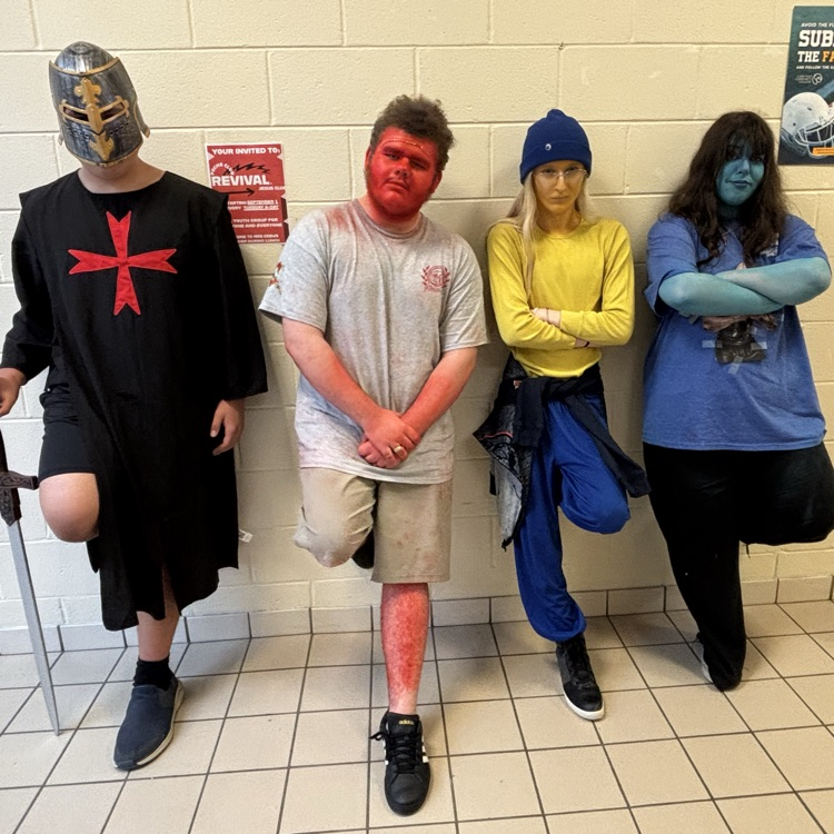 Students posed on a wall