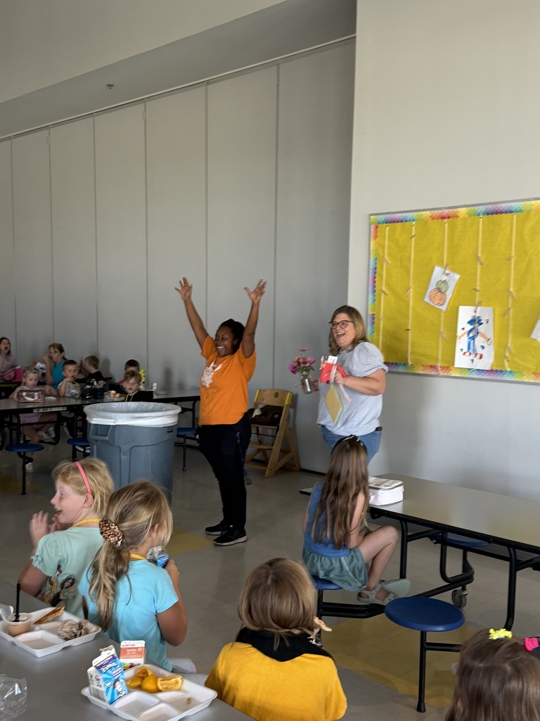 celebrating a custodian in the lunch room with elementary students