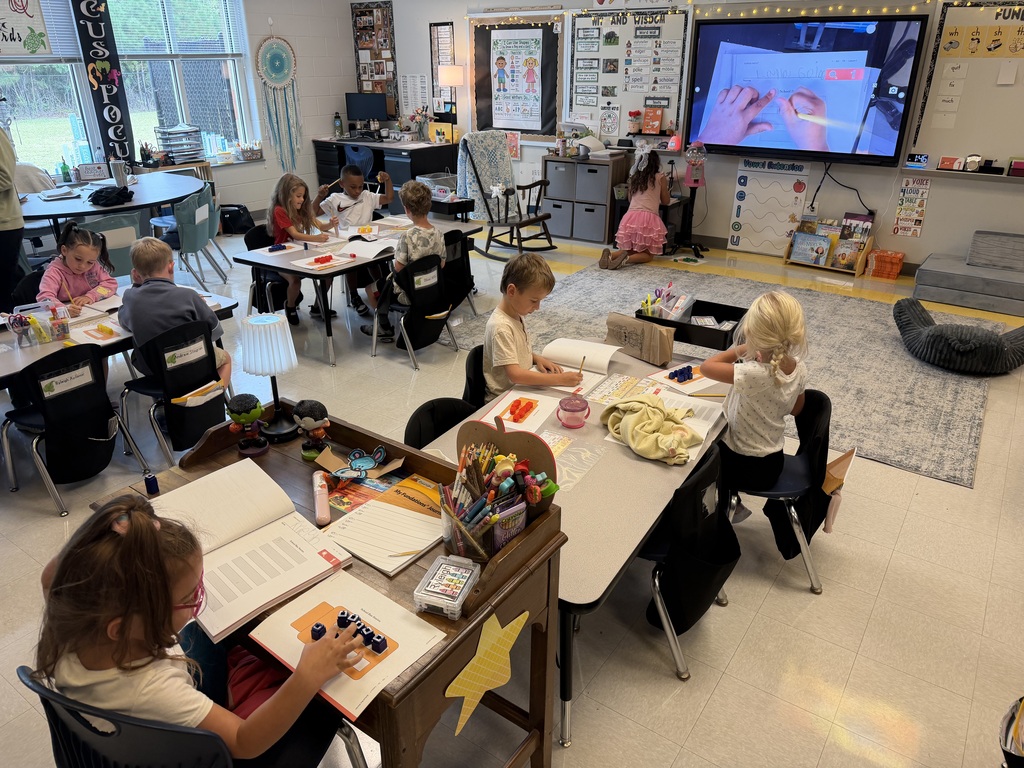 first grade working on a math activity at their tables