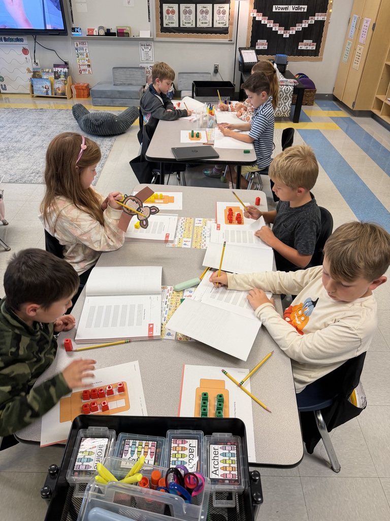 first grade working on a math activity at their tables