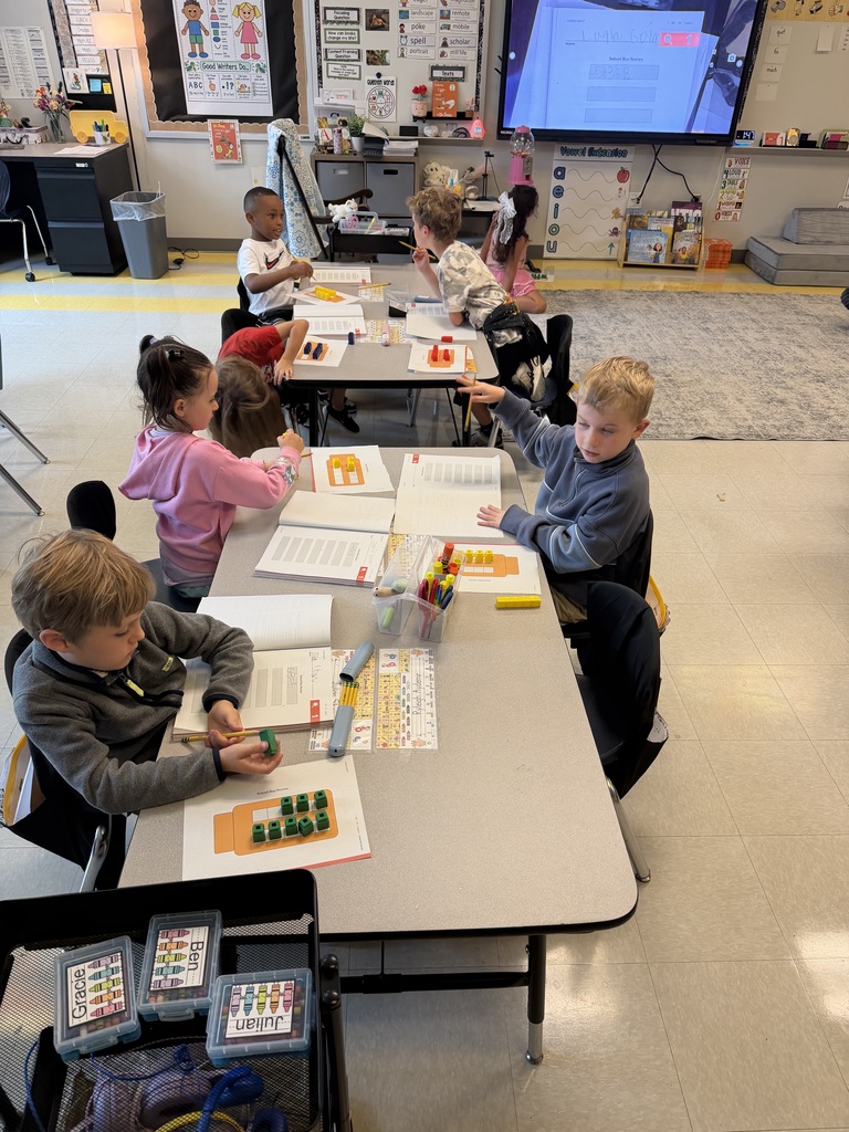 first grade working on a math activity at their tables