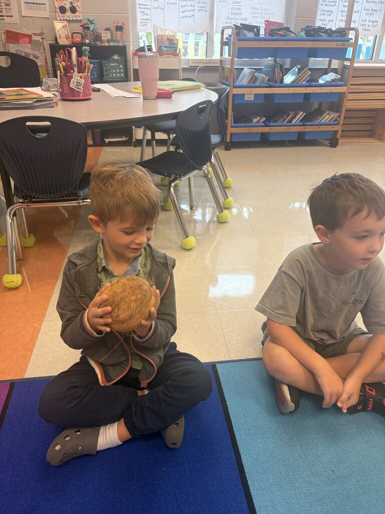 student holding a coconut