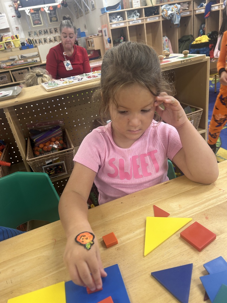 PreK students playing with shape blocks