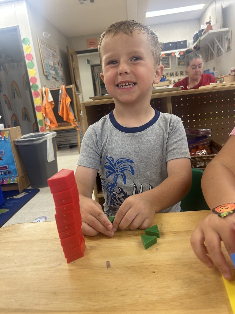 PreK students playing with shape blocks