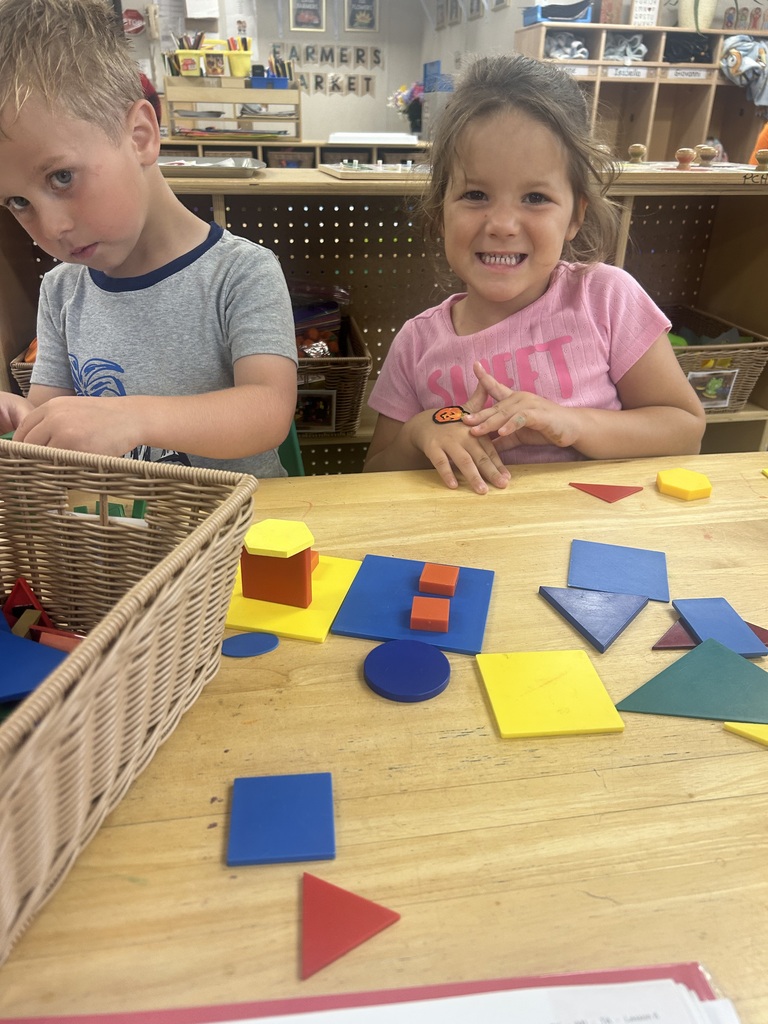PreK students playing with shape blocks