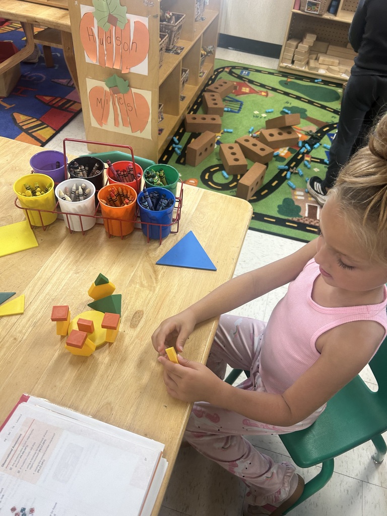 PreK students playing with shape blocks