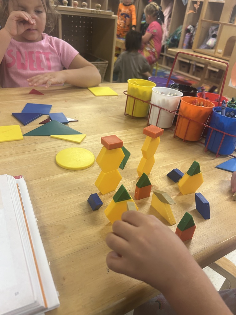 PreK students playing with shape blocks