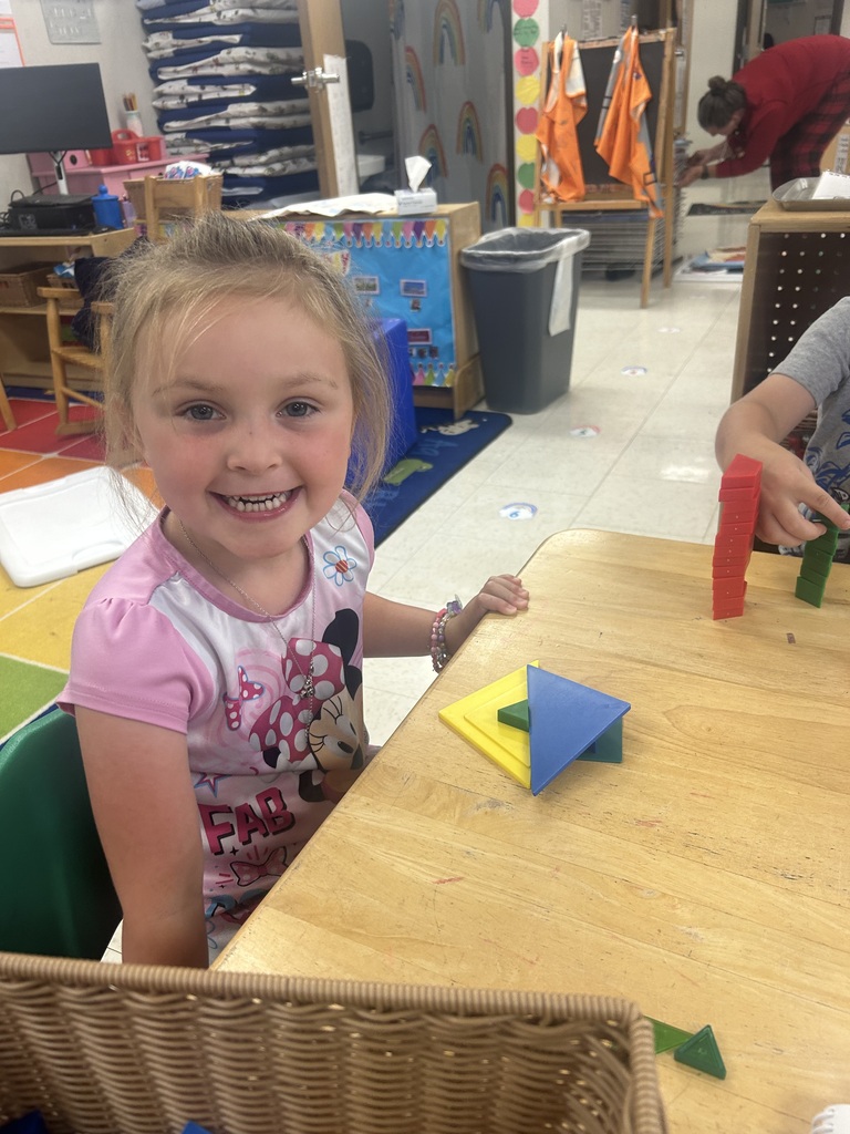 PreK students playing with shape blocks