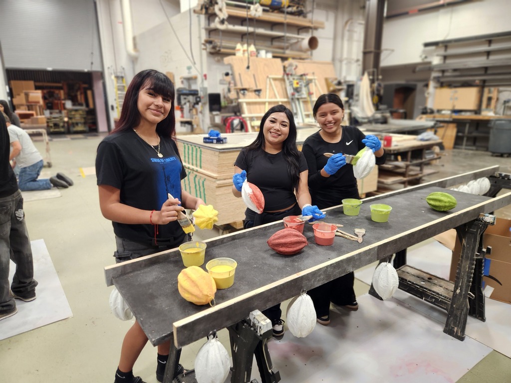 students creating fruit for hispanic heritage month displays