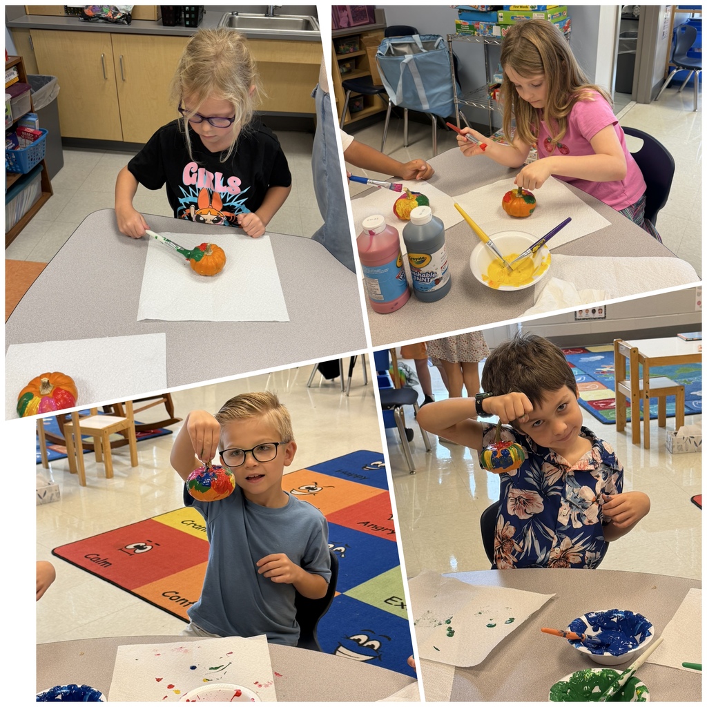 first graders painting pumpkins