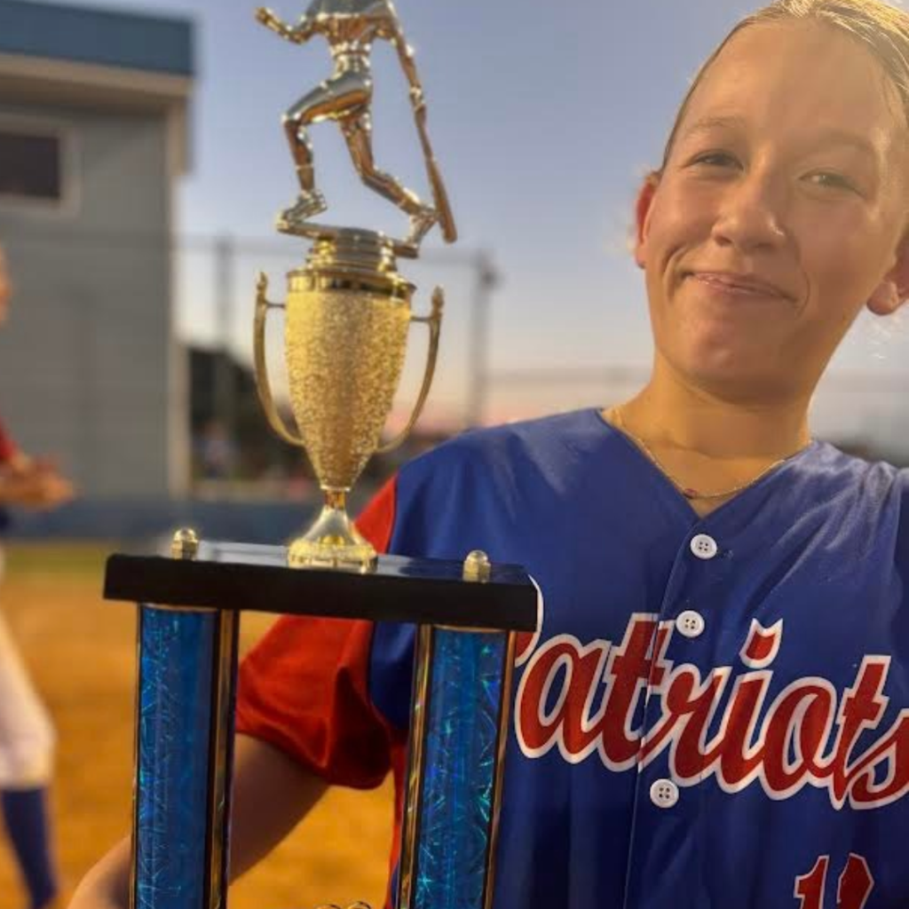 softball team player holding trophy