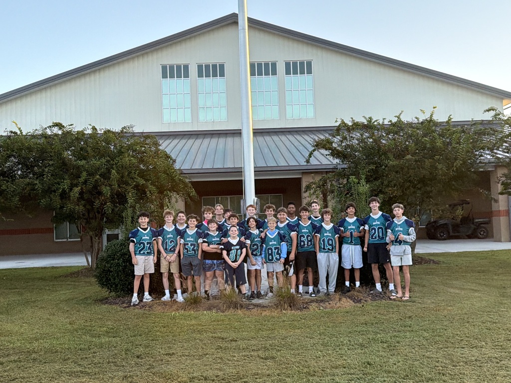 SCM Football students opening car doors for elementary students in the morning