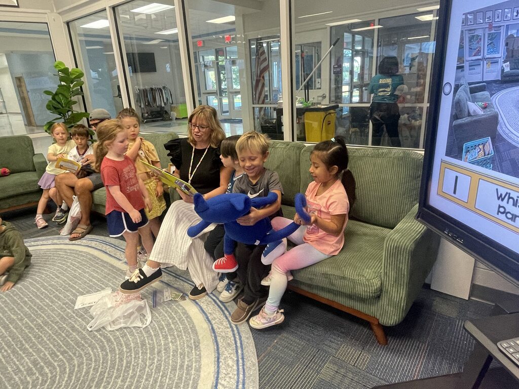 students sitting on the couch reading book fair books