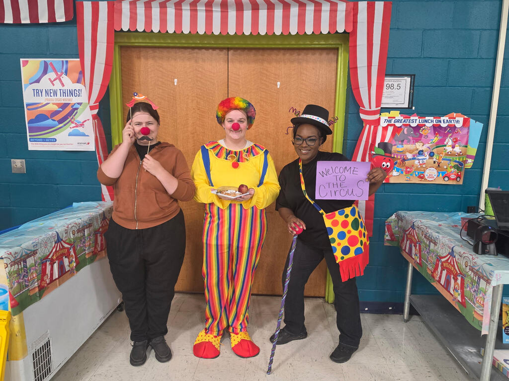 Child Nutrition Staff standing in cafeteria wearing FESTIVE circus theme costumes