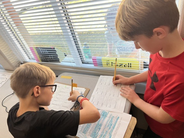 4th grade students working in groups on an assignment