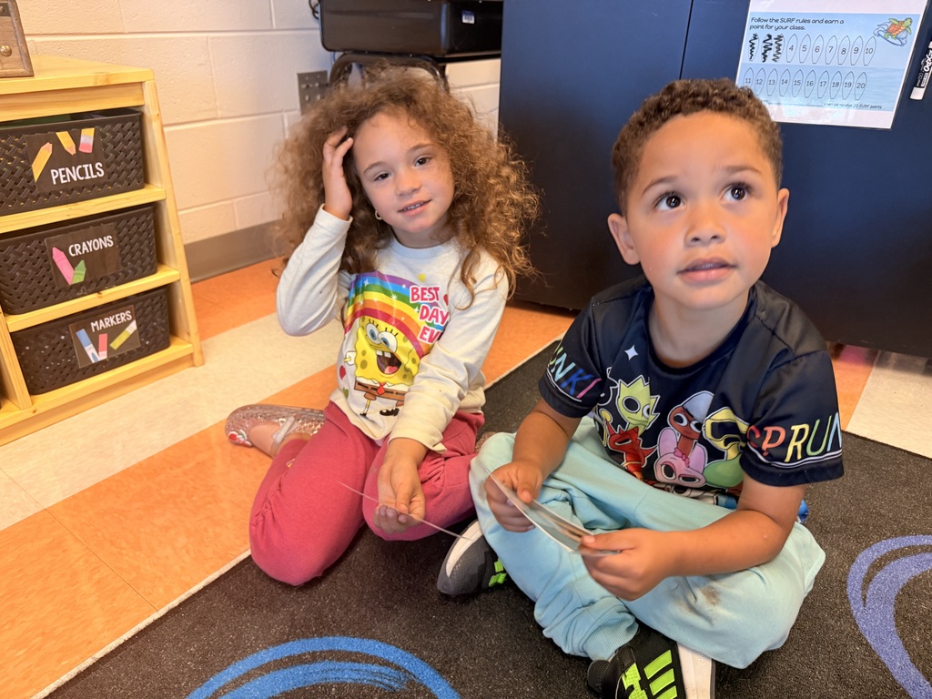 Kindergarten students working together in pairs