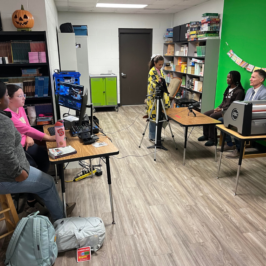 student broadcast team with superintendent