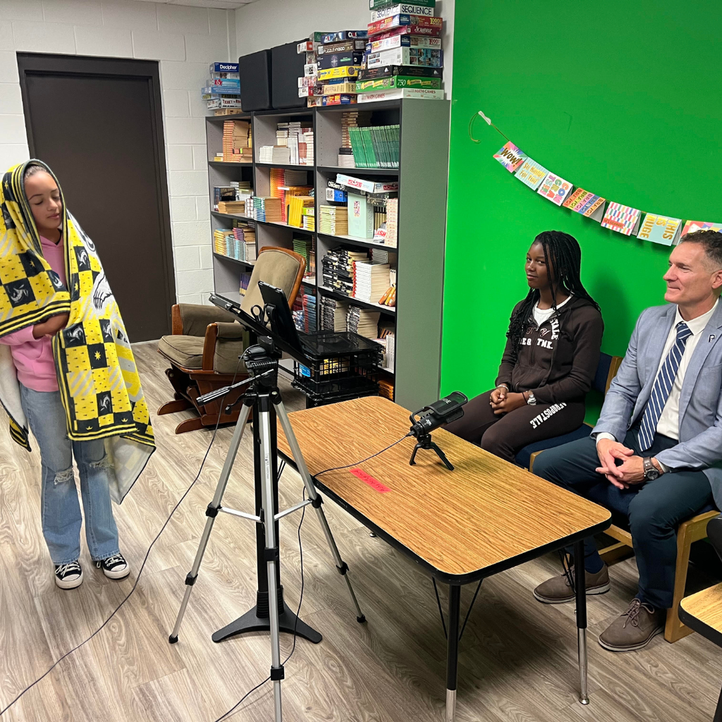 student broadcast team with superintendent