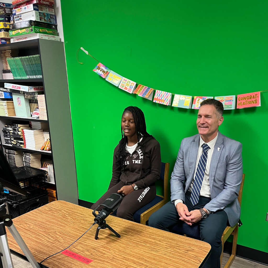 superintendent with student news anchor