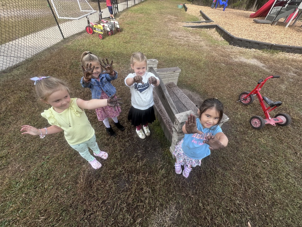 PreK with muddy hands 