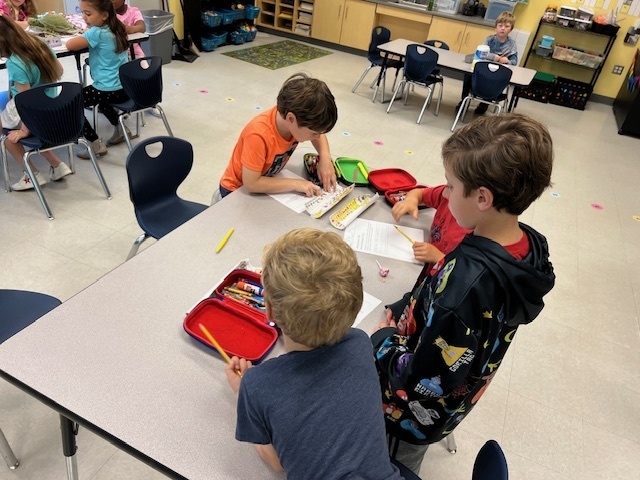 4th grade student helping a kindergartener