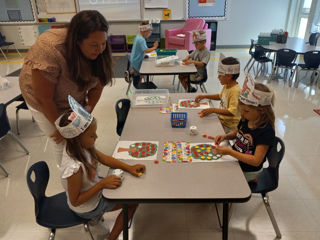Kindergarten playing a math game at tables
