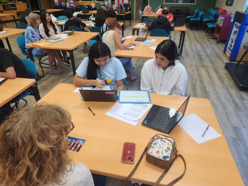 students and volunteer sharing assignment