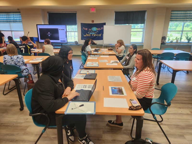 students working with volunteers