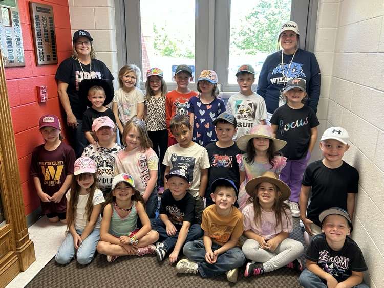1st grade students and teachers taking a picture wearing hats for hat day
