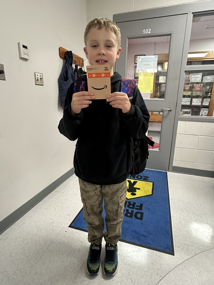 student posing with their amazon attendance reward 