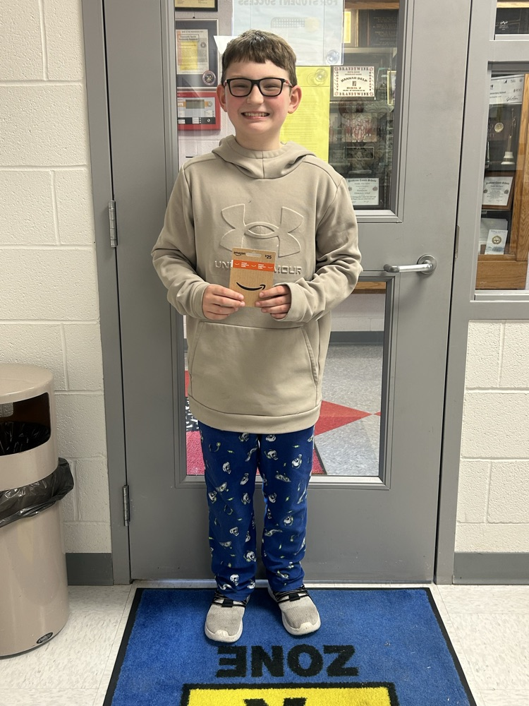 student posing with their amazon attendance reward 