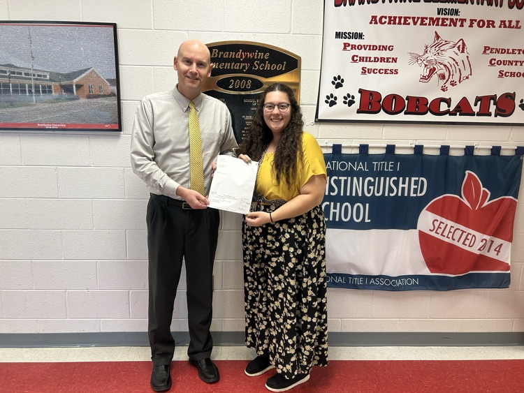 Mr. Lambert and Miss Wright posing with donated check