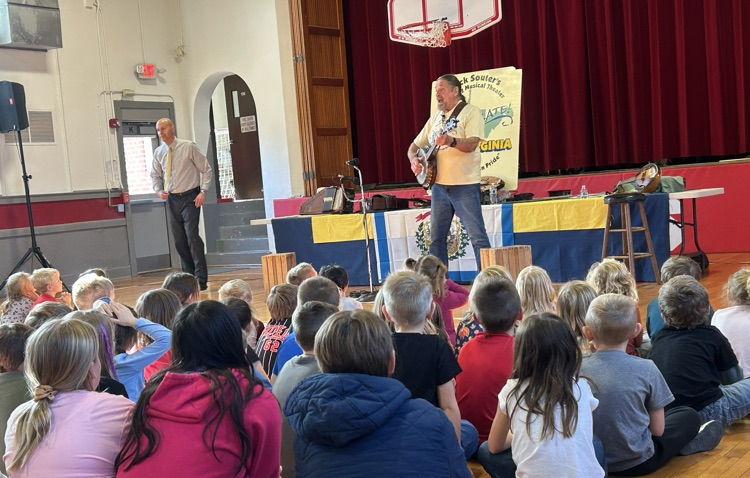MicK Souter performing a song for students 