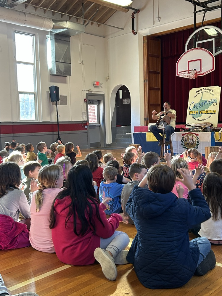 MicK Souter performing a song for students 