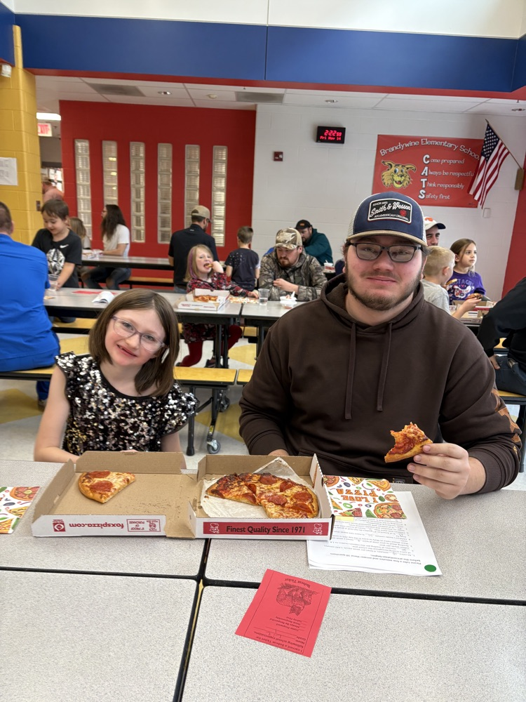 students and their dad making pizza
