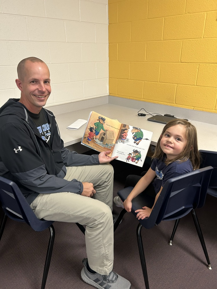 student and their guest reading a book