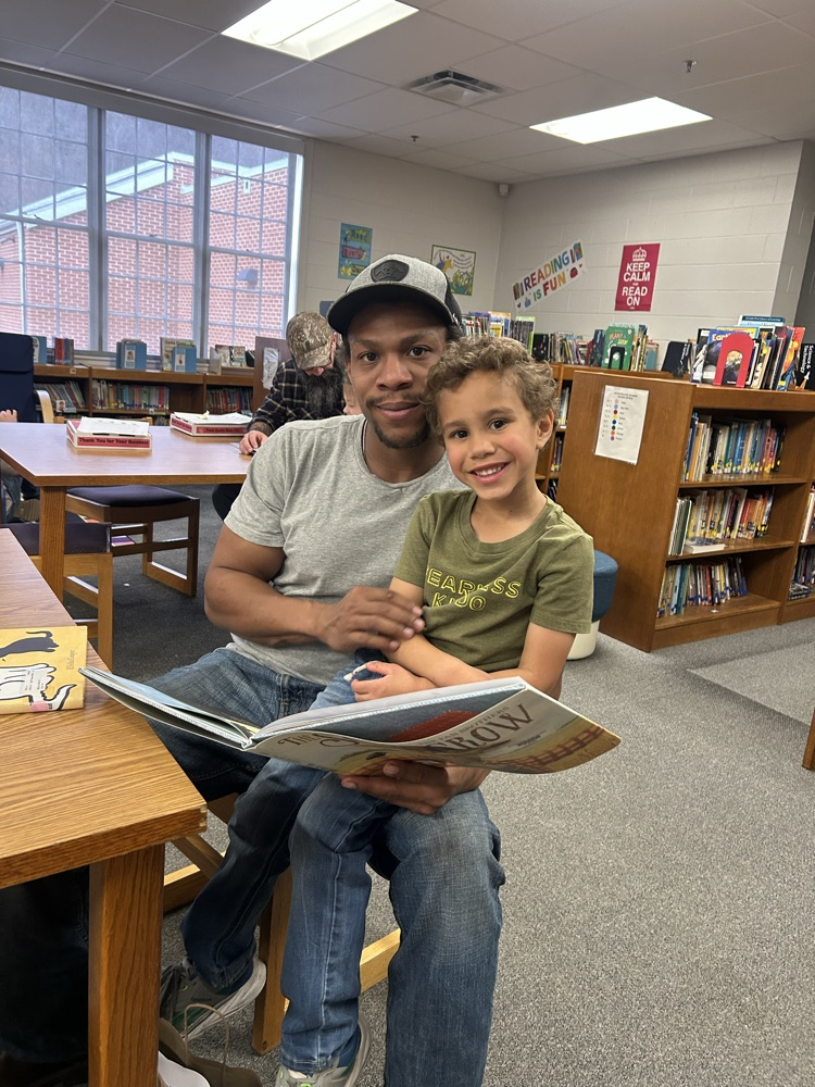student and their guest reading a book