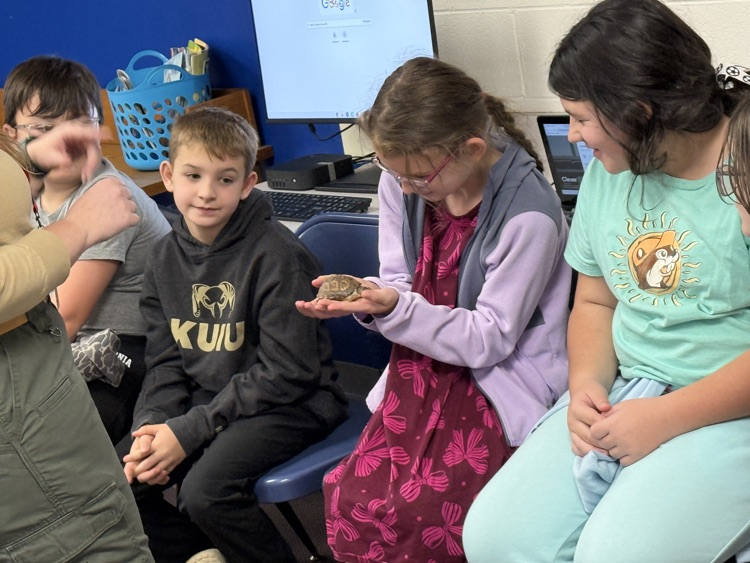 Students holding turtle.